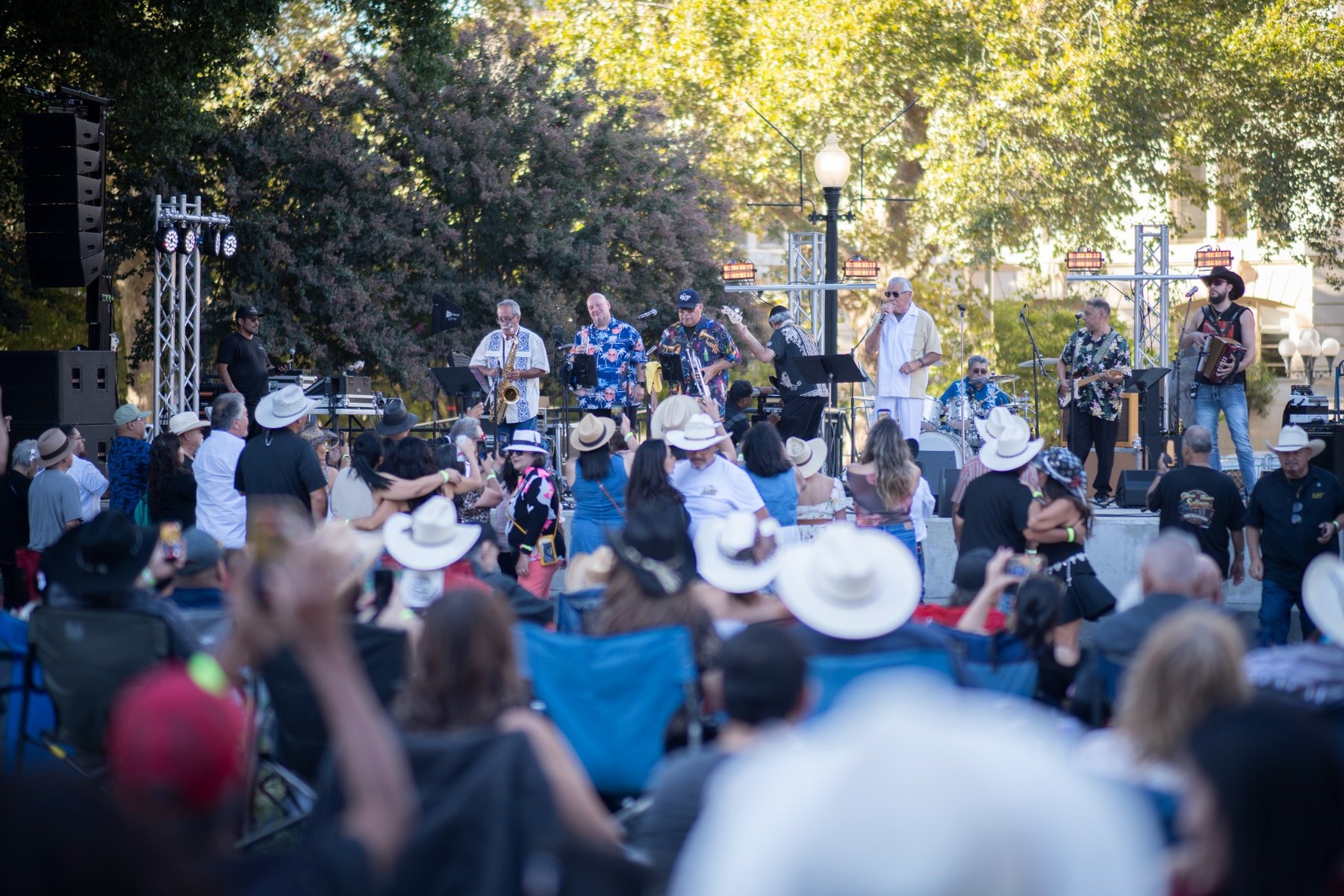 Ruben Ramos and band performing for a large crowd at the 18th Annual Tejano Conjunto Festival Sacramento